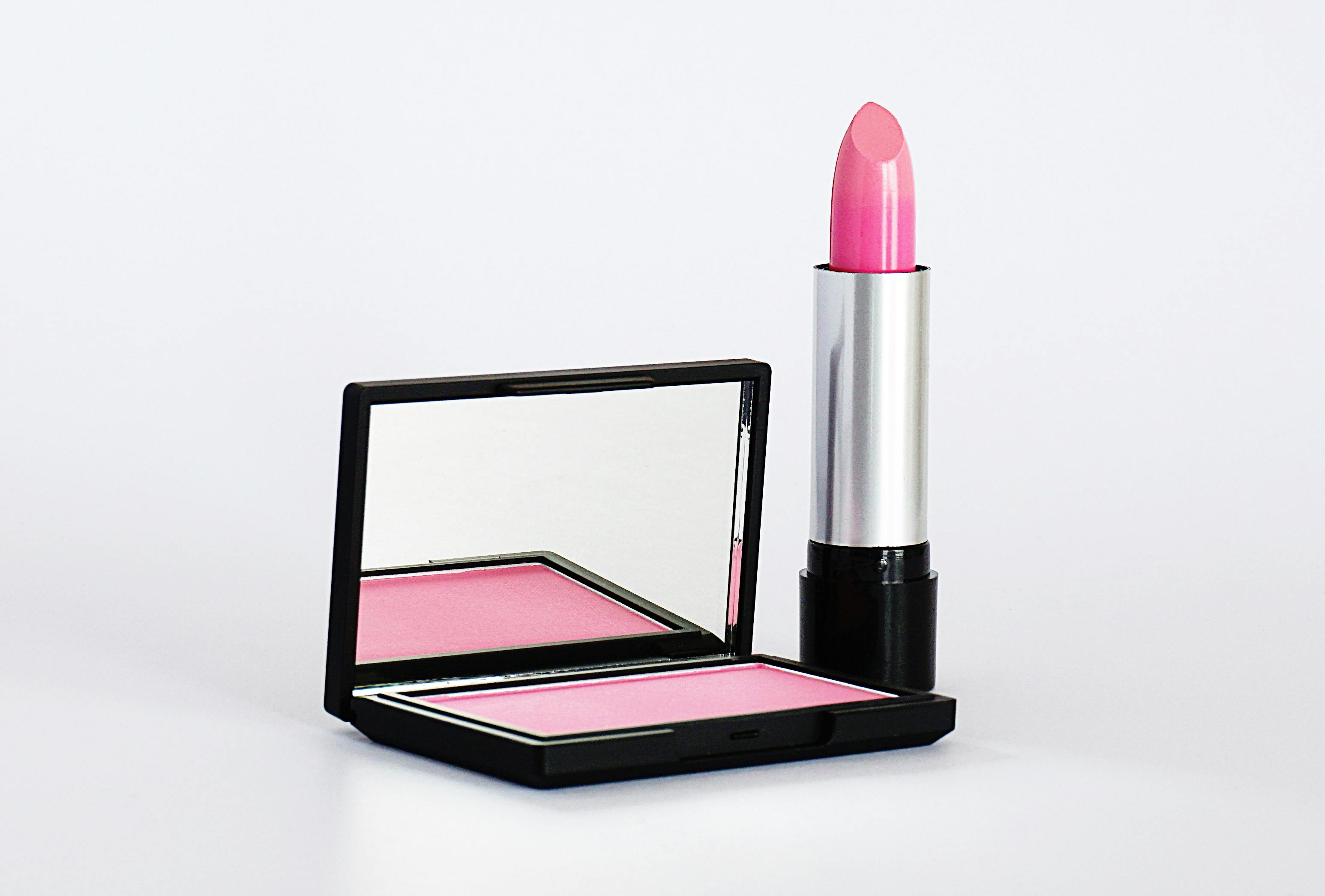 Stylish pink lipstick and blush makeup set on a white background, perfect for beauty and cosmetics branding.